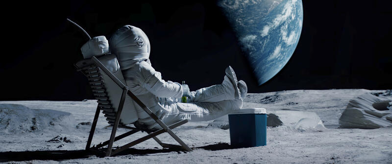 An astronaut sitting on the Moon in a lawn chair